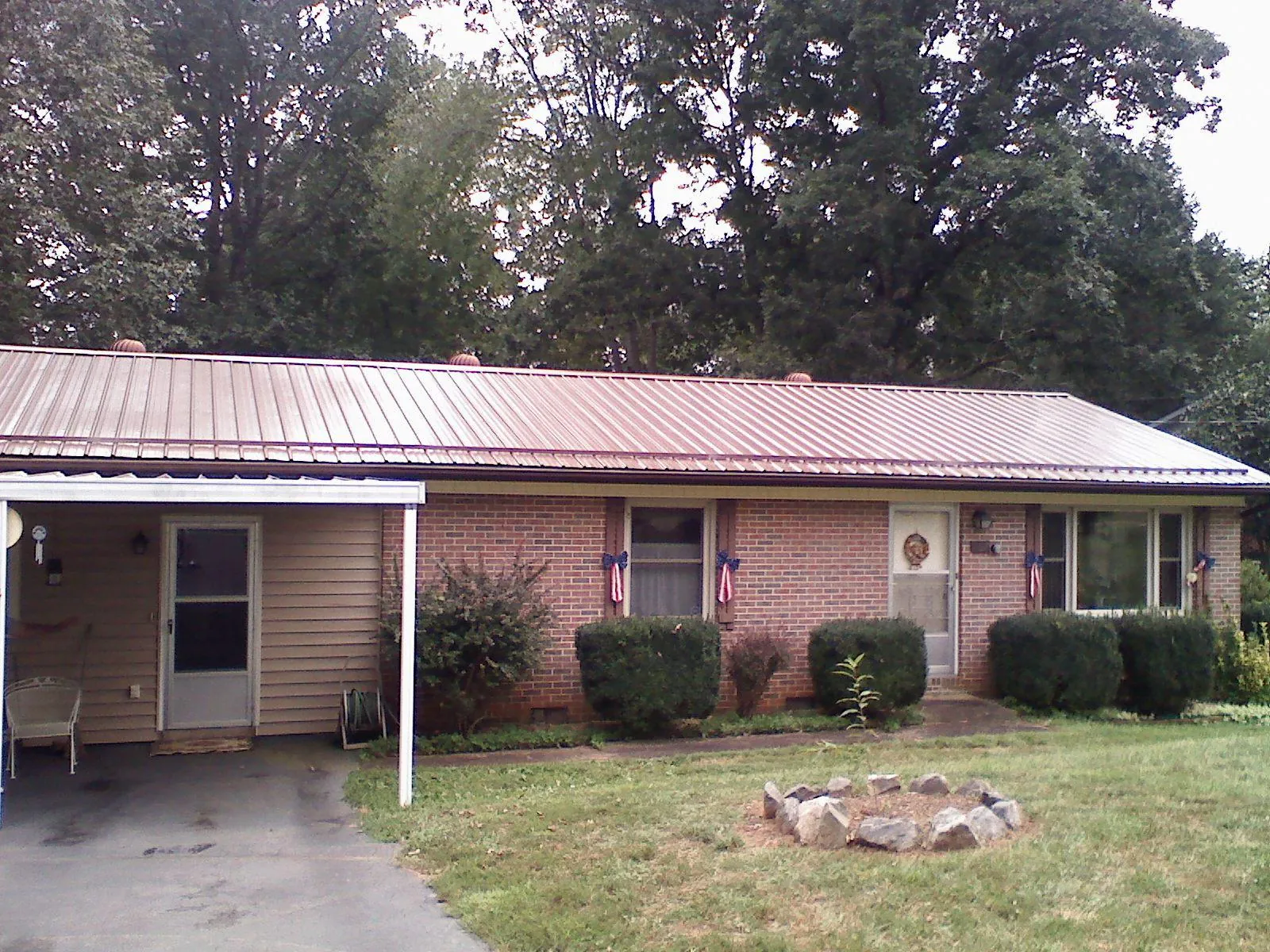 Bronze metal roof and carport on a brick ranch home — Roof Repair work by our crew in Plymouth Meeting